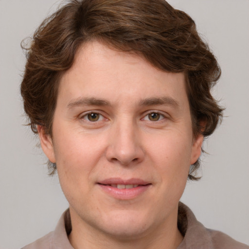 Joyful white adult male with medium  brown hair and grey eyes