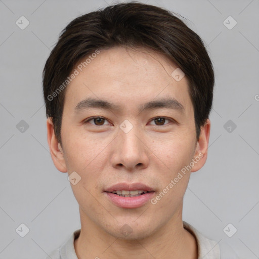 Joyful asian young-adult male with short  brown hair and brown eyes