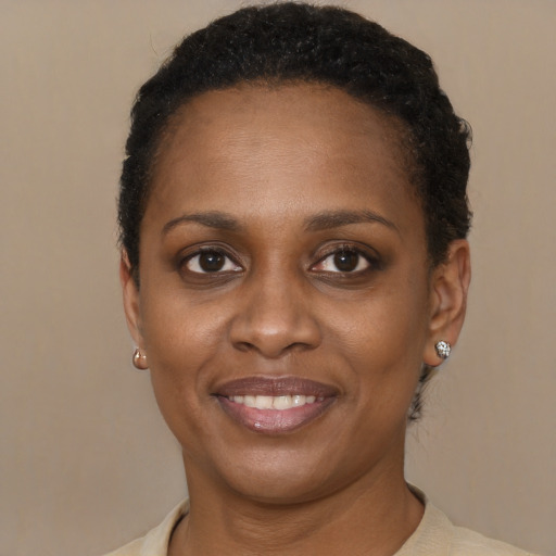 Joyful black young-adult female with short  brown hair and brown eyes