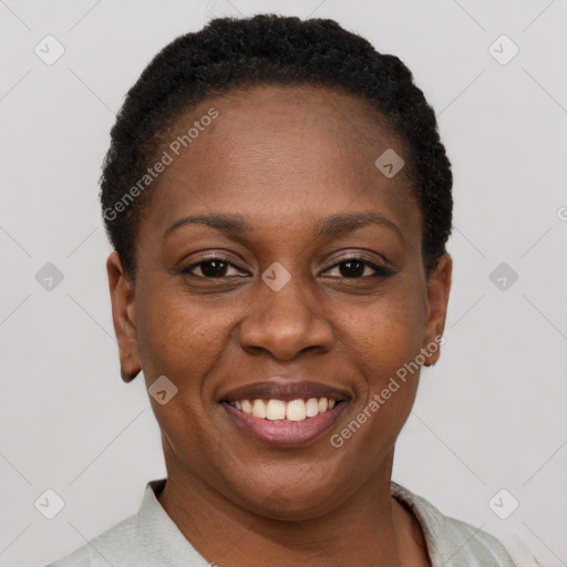 Joyful black young-adult female with short  brown hair and brown eyes