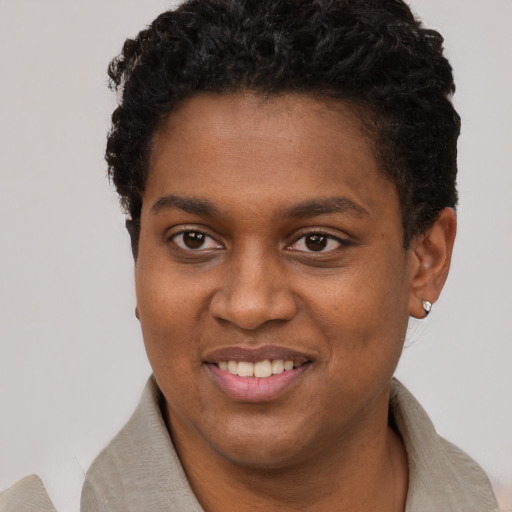 Joyful black young-adult female with short  black hair and brown eyes