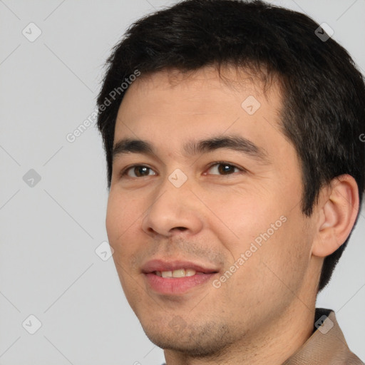 Joyful white young-adult male with short  black hair and brown eyes