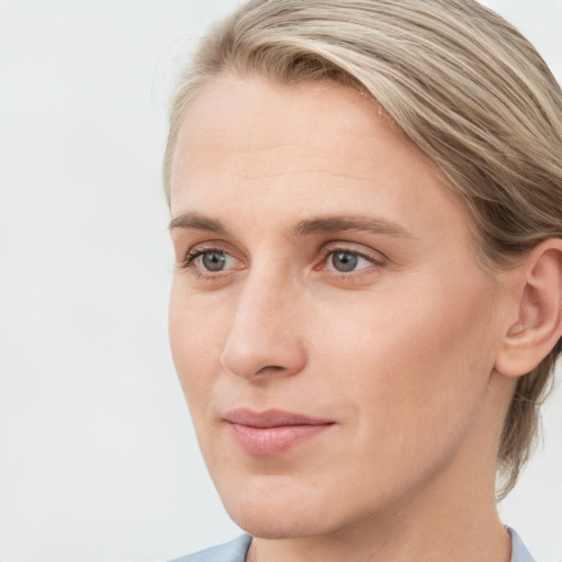 Joyful white young-adult female with medium  brown hair and blue eyes