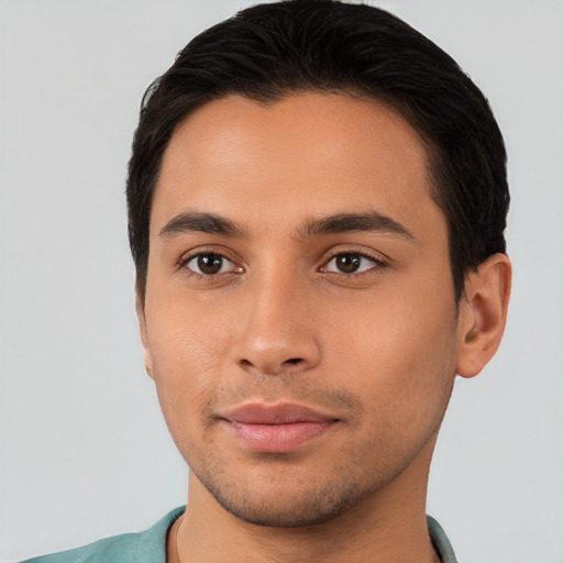 Joyful latino young-adult male with short  brown hair and brown eyes