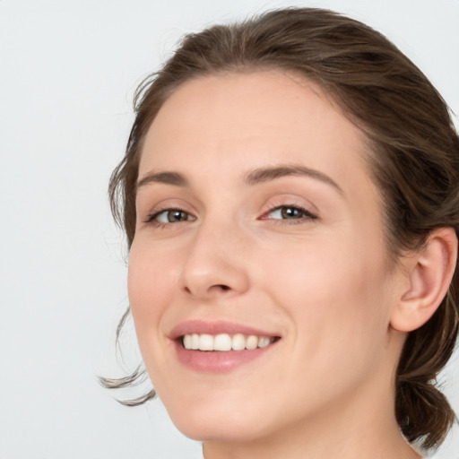 Joyful white young-adult female with medium  brown hair and blue eyes