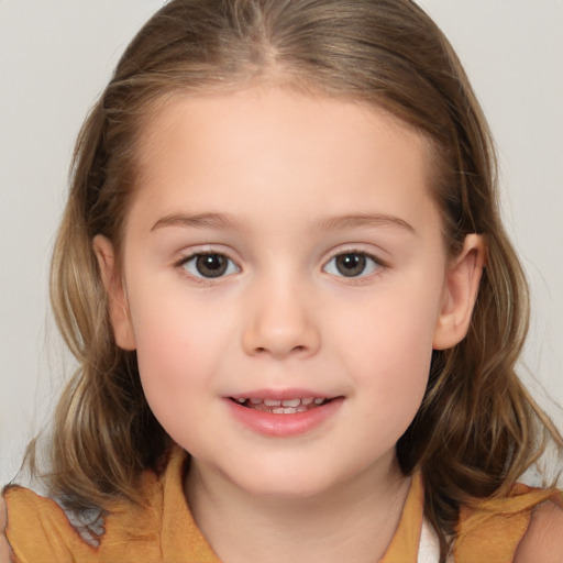 Joyful white child female with medium  brown hair and brown eyes