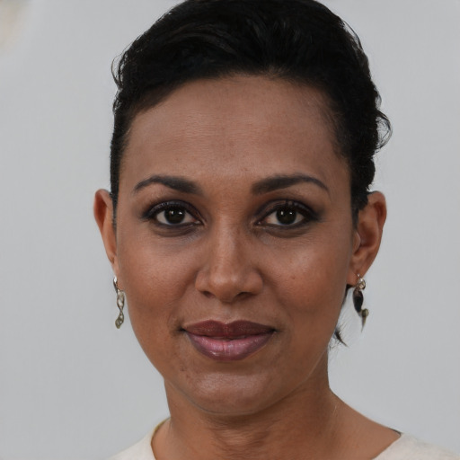 Joyful black young-adult female with short  brown hair and brown eyes
