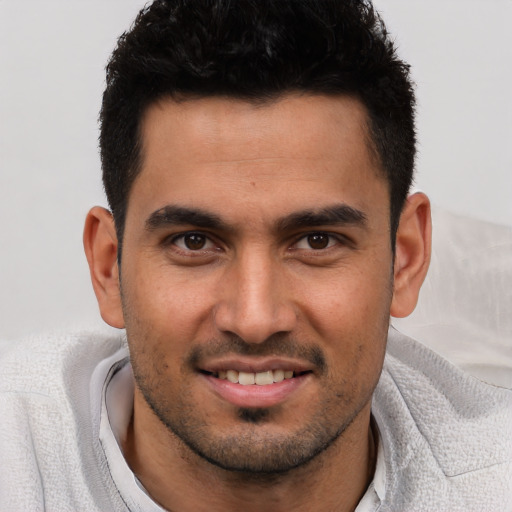 Joyful white young-adult male with short  black hair and brown eyes