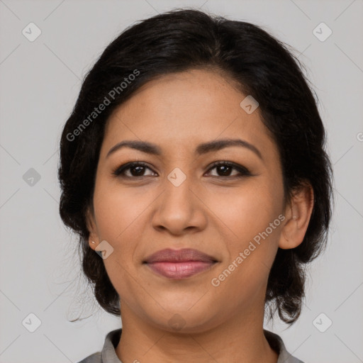 Joyful latino adult female with medium  brown hair and brown eyes