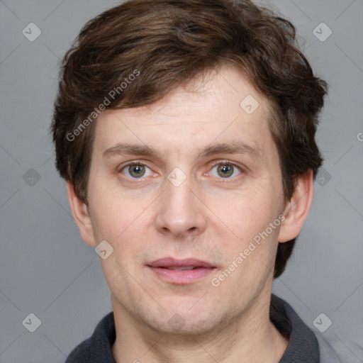 Joyful white adult male with short  brown hair and grey eyes