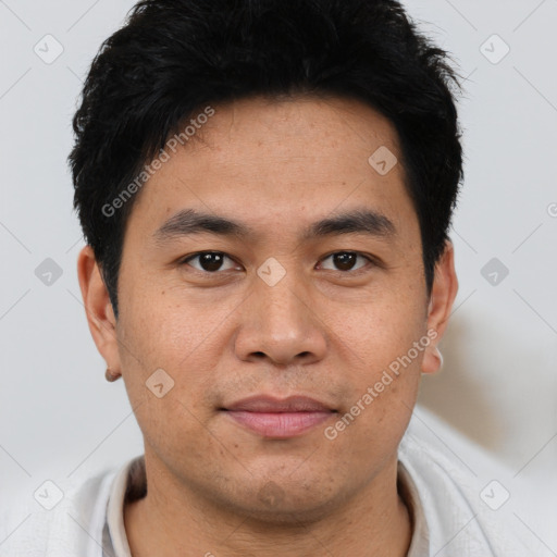 Joyful asian young-adult male with short  brown hair and brown eyes