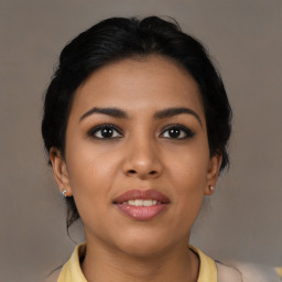 Joyful latino young-adult female with medium  brown hair and brown eyes