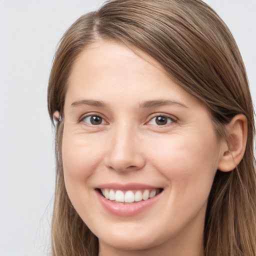 Joyful white young-adult female with long  brown hair and grey eyes