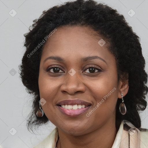 Joyful black young-adult female with long  brown hair and brown eyes