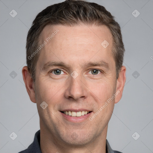 Joyful white adult male with short  brown hair and grey eyes