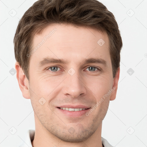 Joyful white young-adult male with short  brown hair and grey eyes