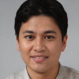 Joyful asian young-adult male with short  brown hair and brown eyes