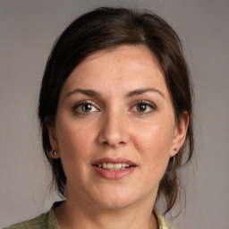 Joyful white adult female with medium  brown hair and brown eyes