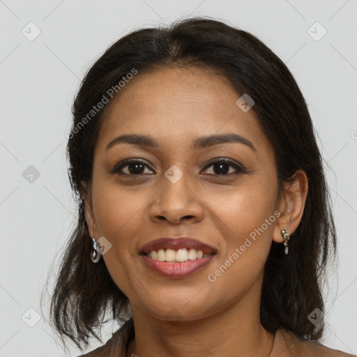 Joyful latino young-adult female with medium  brown hair and brown eyes