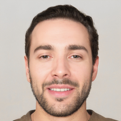 Joyful white young-adult male with short  black hair and brown eyes