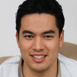 Joyful latino young-adult male with short  brown hair and brown eyes