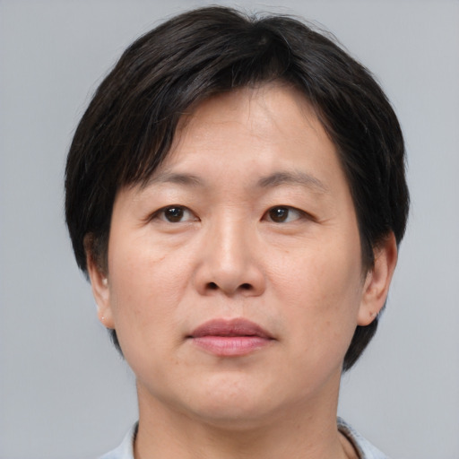 Neutral asian adult male with short  brown hair and brown eyes