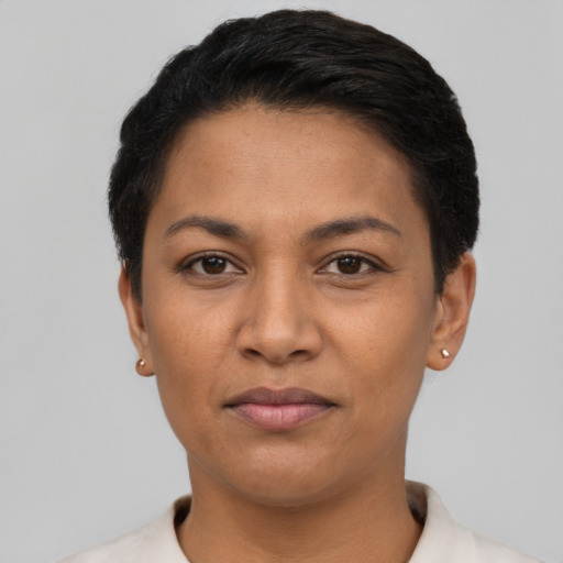 Joyful latino young-adult female with short  black hair and brown eyes