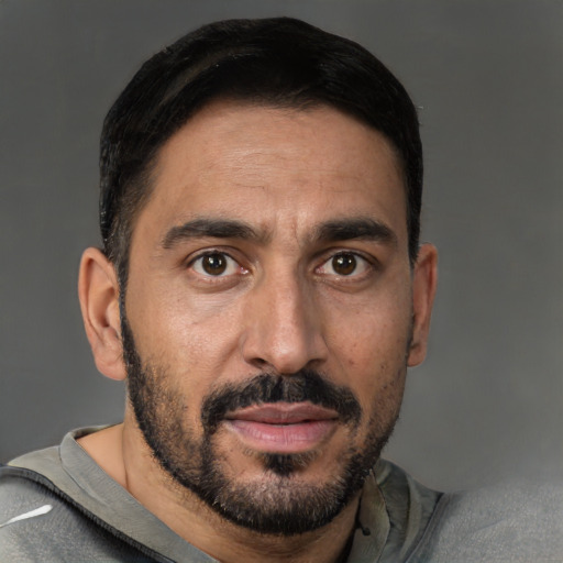 Joyful white adult male with short  black hair and brown eyes
