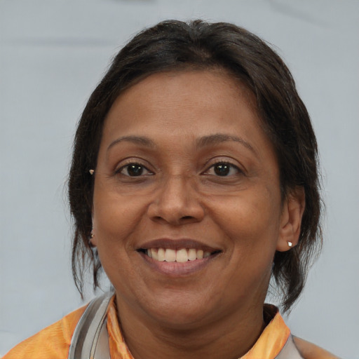 Joyful white adult female with medium  brown hair and brown eyes