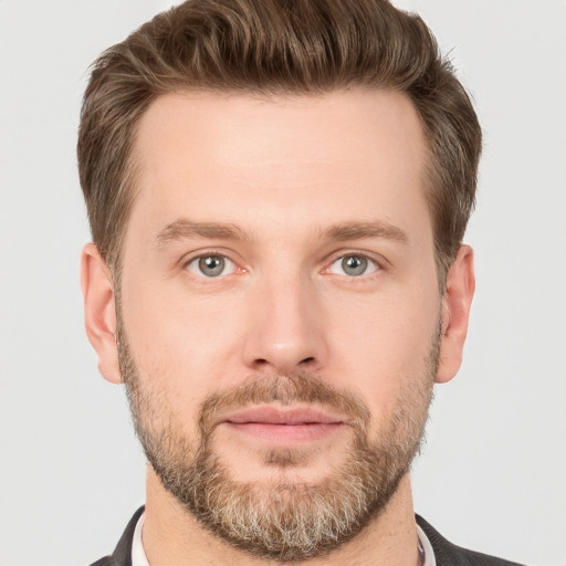 Joyful white adult male with short  brown hair and grey eyes