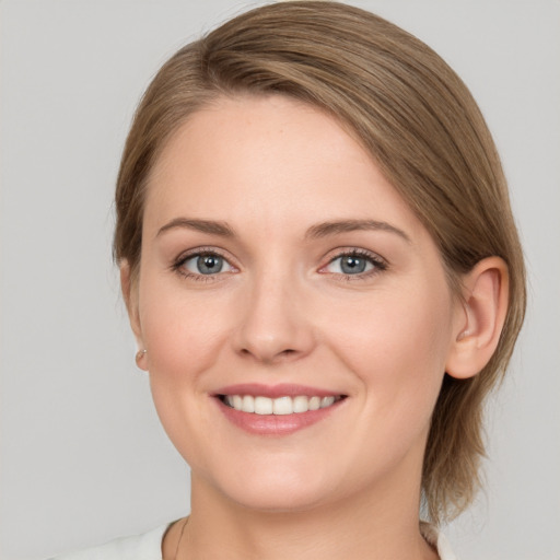 Joyful white young-adult female with medium  brown hair and grey eyes