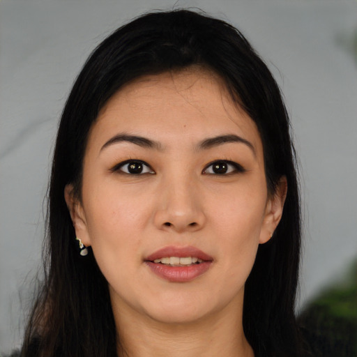 Joyful asian young-adult female with long  black hair and brown eyes