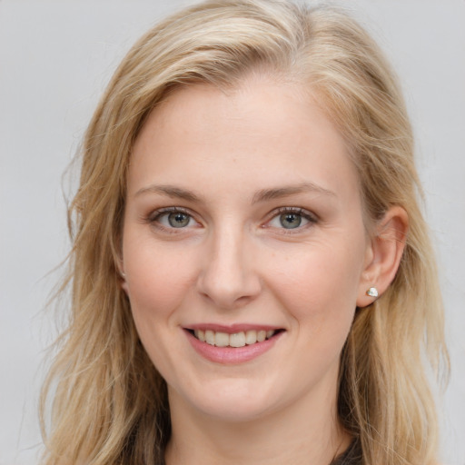 Joyful white young-adult female with long  brown hair and blue eyes