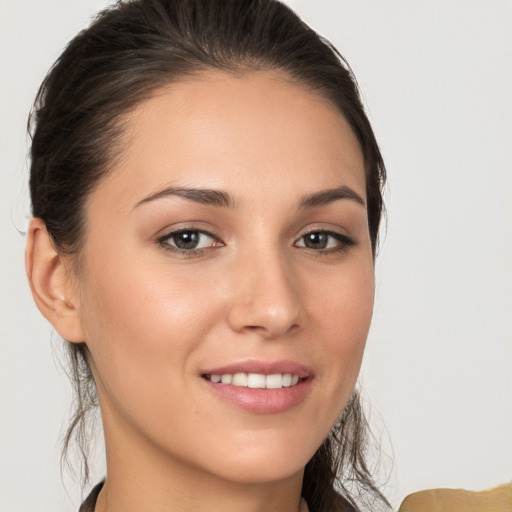 Joyful white young-adult female with medium  brown hair and brown eyes