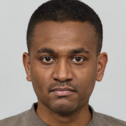 Neutral black young-adult male with short  black hair and brown eyes