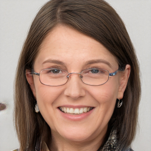 Joyful white adult female with long  brown hair and brown eyes