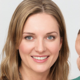 Joyful white young-adult female with medium  brown hair and green eyes