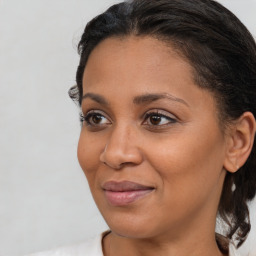 Joyful black young-adult female with medium  brown hair and brown eyes