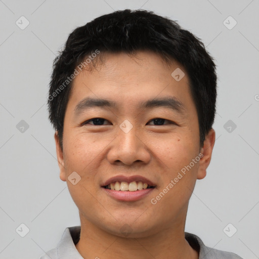 Joyful asian young-adult male with short  black hair and brown eyes