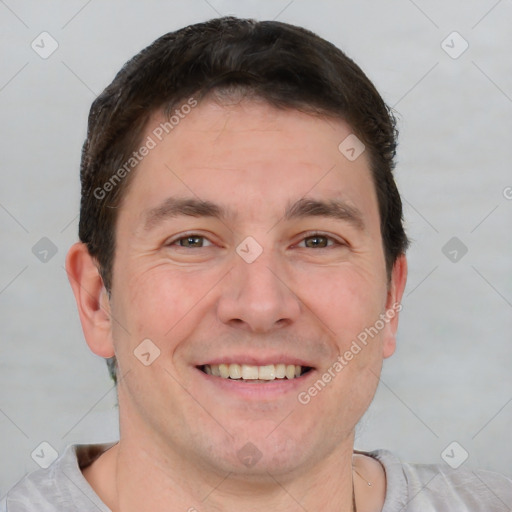 Joyful white adult male with short  brown hair and brown eyes