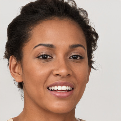 Joyful latino young-adult female with short  brown hair and brown eyes