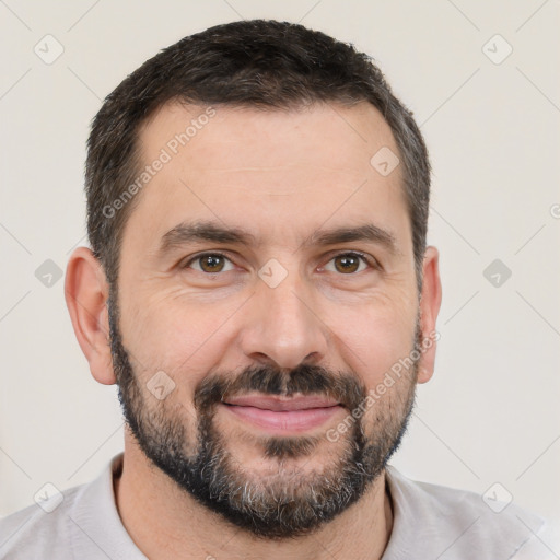 Joyful white adult male with short  black hair and brown eyes