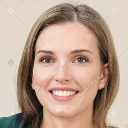 Joyful white young-adult female with medium  brown hair and grey eyes