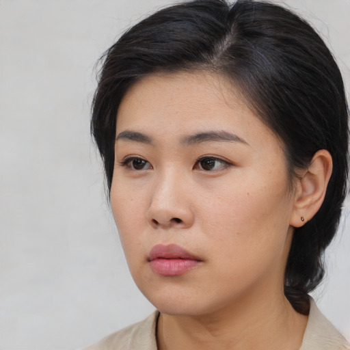 Neutral asian young-adult female with medium  brown hair and brown eyes