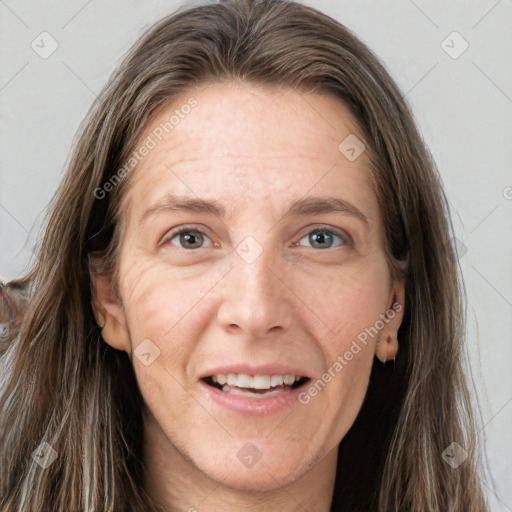 Joyful white adult female with long  brown hair and grey eyes