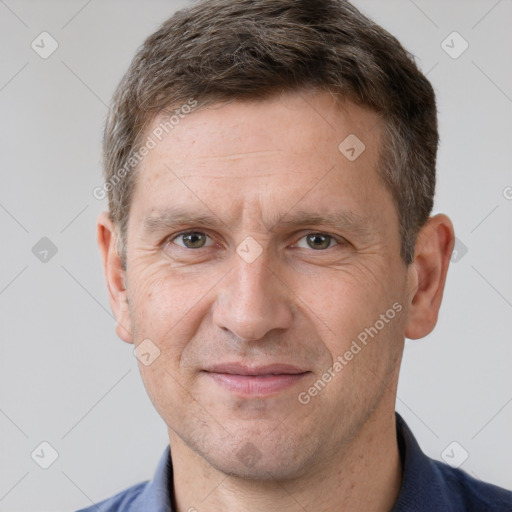 Joyful white adult male with short  brown hair and grey eyes