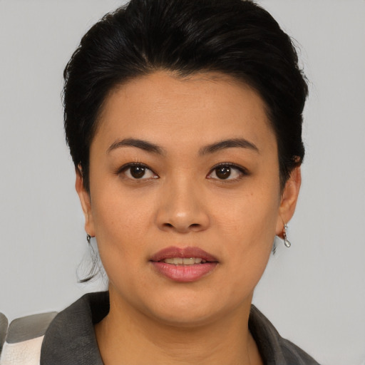 Joyful asian young-adult female with short  black hair and brown eyes
