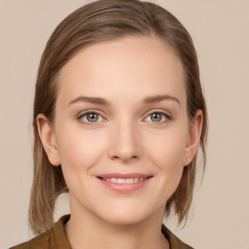 Joyful white young-adult female with medium  brown hair and grey eyes