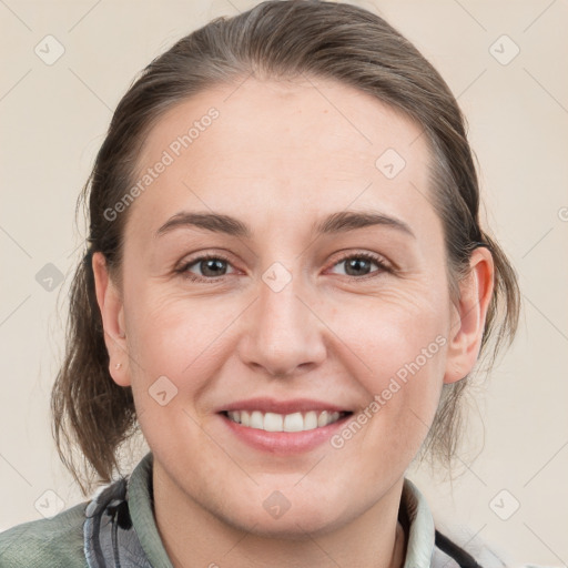 Joyful white young-adult female with medium  brown hair and grey eyes