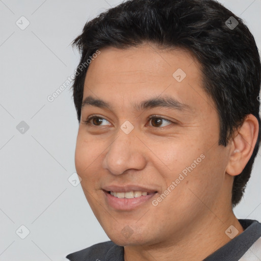 Joyful white young-adult male with short  black hair and brown eyes